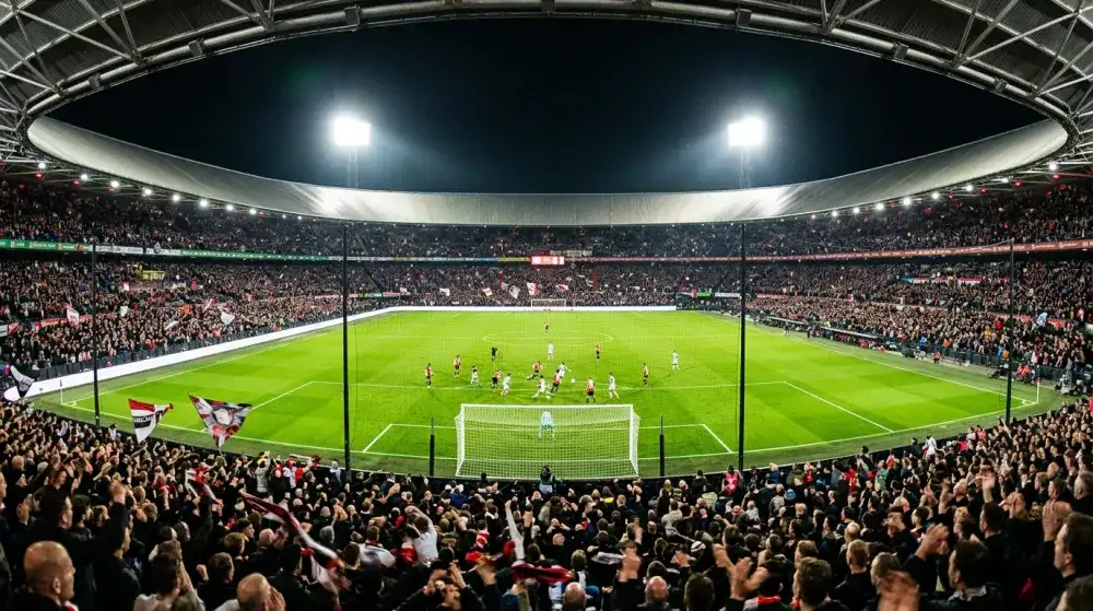 Panoramic view of a football stadium during a night match with bright floodlights